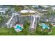 An aerial view of the condo community highlighting the lush landscaping and inviting community pool areas at 6165 Carrier Dr # 2605, Orlando, FL 32819