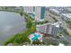 Beautiful aerial view highlighting a lakeside condominium community with gorgeous pool and lush green landscape at 6165 Carrier Dr # 2605, Orlando, FL 32819