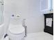 Modern bathroom featuring a toilet, and a dark vanity against sleek white tiled walls at 6165 Carrier Dr # 2605, Orlando, FL 32819