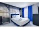Cozy bedroom featuring a queen bed, blue curtains, and city skyline mural for a stylish retreat at 6165 Carrier Dr # 2605, Orlando, FL 32819