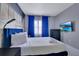 Modern bedroom featuring a queen bed, blue accents, and a city mural, perfect for relaxation at 6165 Carrier Dr # 2605, Orlando, FL 32819