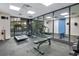 Well-equipped gym with modern exercise machines and ample mirror space at 6165 Carrier Dr # 2605, Orlando, FL 32819