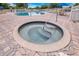 Inviting in-ground hot tub with a unique spiral step design for easy access at 6165 Carrier Dr # 2605, Orlando, FL 32819