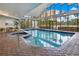Enclosed swimming pool area featuring an abundance of natural light and comfortable seating at 6165 Carrier Dr # 2605, Orlando, FL 32819