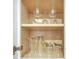 Wine glasses and other drinking glasses arranged in a white kitchen cabinet, providing ample storage at 6165 Carrier Dr # 2605, Orlando, FL 32819