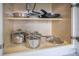 Organized pots and pans inside a white kitchen cabinet, providing ample storage space at 6165 Carrier Dr # 2605, Orlando, FL 32819