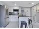 Modern kitchen featuring stainless steel appliances, white cabinetry, and a breakfast bar at 6165 Carrier Dr # 2605, Orlando, FL 32819