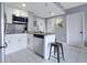 Contemporary kitchen with stainless steel appliances, white cabinets, and granite countertops at 6165 Carrier Dr # 2605, Orlando, FL 32819