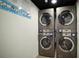 Convenient laundry room featuring multiple stacked washer and dryer units at 6165 Carrier Dr # 2605, Orlando, FL 32819