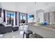 Modern living room with stainless steel appliances, a sleek couch, and balcony access at 6165 Carrier Dr # 2605, Orlando, FL 32819
