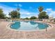 Large community swimming pool with multiple lounge chairs and lush landscaping at 6165 Carrier Dr # 2605, Orlando, FL 32819