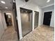 Bathroom with light brown tiled floor, adjacent sink, and black door at 62 W Colonial Dr # 302, Orlando, FL 32801