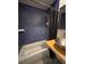Bathroom with blue tiled walls, a shower/tub combination, and stainless steel basin sink at 62 W Colonial Dr # 302, Orlando, FL 32801