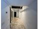Hallway featuring concrete floors, white brick walls and black metal framed doorway at 62 W Colonial Dr # 302, Orlando, FL 32801