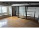 Open living room with hardwood floors, large windows, and sliding glass doors to an open balcony at 62 W Colonial Dr # 302, Orlando, FL 32801