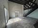 Spacious loft featuring concrete floors, exposed brick, large window, black staircase, and wood ceiling at 62 W Colonial Dr # 302, Orlando, FL 32801