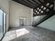 Spacious loft featuring concrete floors, exposed brick, large window, black staircase, and wood ceiling at 62 W Colonial Dr # 302, Orlando, FL 32801