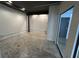 The empty room has a concrete floor, white walls, and black ceiling beams at 62 W Colonial Dr # 302, Orlando, FL 32801