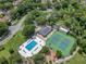 Aerial view of the community pool, clubhouse, tennis courts, and playground, surrounded by lush greenery at 651 Oak Hollow Way, Altamonte Springs, FL 32714