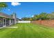 Expansive backyard boasts a well-maintained lawn, privacy fence, and mature trees, perfect for recreation at 651 Oak Hollow Way, Altamonte Springs, FL 32714
