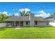 Lovely backyard featuring a lush lawn, screened-in patio, and mature landscaping for outdoor enjoyment at 651 Oak Hollow Way, Altamonte Springs, FL 32714