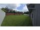 Spacious backyard featuring green grass and a brick privacy wall at 651 Oak Hollow Way, Altamonte Springs, FL 32714