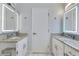 Bathroom featuring granite countertops and modern, lighted mirrors with digital displays above white cabinets at 651 Oak Hollow Way, Altamonte Springs, FL 32714