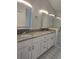 Bathroom with granite countertops, double sinks, and a stand-up shower at 651 Oak Hollow Way, Altamonte Springs, FL 32714