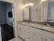 Granite countertop vanity with double sinks and lighted medicine cabinet provides modern bathroom amenities at 651 Oak Hollow Way, Altamonte Springs, FL 32714