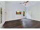 This bedroom features dark hardwood flooring, a ceiling fan and a wall-mounted television at 651 Oak Hollow Way, Altamonte Springs, FL 32714