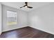 Bedroom features hardwood floors, a ceiling fan, and bright natural light at 651 Oak Hollow Way, Altamonte Springs, FL 32714