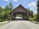 A rustic, wood-covered bridge offers a charming, shaded passage framed by lush trees and greenery at 651 Oak Hollow Way, Altamonte Springs, FL 32714