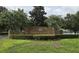 A warm welcome to Country Creek, highlighted by a brick entrance sign surrounded by lush, manicured greenery at 651 Oak Hollow Way, Altamonte Springs, FL 32714