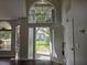 Bright foyer featuring high ceilings, dark floors, and a view of the front yard at 651 Oak Hollow Way, Altamonte Springs, FL 32714
