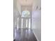 Hallway with soaring ceilings, modern chandelier, dark floors, and clerestory windows at 651 Oak Hollow Way, Altamonte Springs, FL 32714