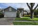 Charming gray two-story home with landscaped yard, mature tree, and a two car garage at 651 Oak Hollow Way, Altamonte Springs, FL 32714