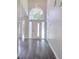 Bright foyer featuring high ceilings, hardwood floors, and an elegant front door with transom window at 651 Oak Hollow Way, Altamonte Springs, FL 32714