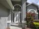 Close up front door of gray house with lots of glass and surrounding landscaped elements at 651 Oak Hollow Way, Altamonte Springs, FL 32714