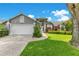 Charming home with a two-car garage, manicured lawn, and colorful landscaping enhancing its curb appeal at 651 Oak Hollow Way, Altamonte Springs, FL 32714