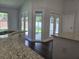 Bright kitchen featuring granite counters and view to screened lanai at 651 Oak Hollow Way, Altamonte Springs, FL 32714
