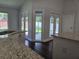 Bright kitchen features granite counters and dark hardwood floors at 651 Oak Hollow Way, Altamonte Springs, FL 32714
