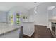 Open floor plan with center island, dark laminate floors and sliding glass doors at 651 Oak Hollow Way, Altamonte Springs, FL 32714