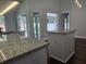 Bright kitchen features granite counters and a kitchen island at 651 Oak Hollow Way, Altamonte Springs, FL 32714