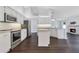 Open kitchen features stainless appliances, granite countertops, and a cozy fireplace at 651 Oak Hollow Way, Altamonte Springs, FL 32714