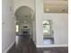 Open living space with arched doorways, wood floors, a fireplace, and a view to the outside at 651 Oak Hollow Way, Altamonte Springs, FL 32714