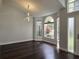 Living room featuring dark floors, modern light fixture, and natural light through picture windows at 651 Oak Hollow Way, Altamonte Springs, FL 32714
