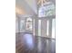 Living room featuring dark floors, lots of light, and a view of the front entry at 651 Oak Hollow Way, Altamonte Springs, FL 32714