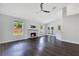 Spacious living room featuring a fireplace, wood floors, and views of the backyard at 651 Oak Hollow Way, Altamonte Springs, FL 32714
