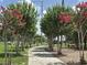 Enjoy lush trees and a sidewalk leading to a playground with swings and various equipment at 651 Oak Hollow Way, Altamonte Springs, FL 32714