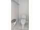 A well-lit lavatory with a modern toilet, toilet paper holder, and practical cleaning supplies at 651 Oak Hollow Way, Altamonte Springs, FL 32714